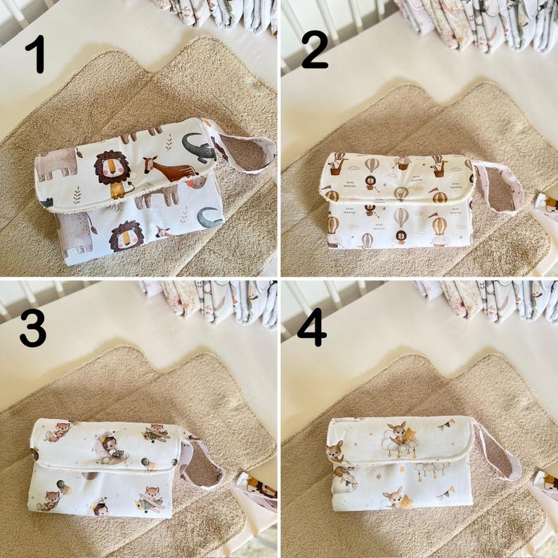 May include: Four different changing pad covers with various designs. The covers are white with different colored patterns. The patterns include animals, hot air balloons, and stars. The covers are all folded and laid out on a beige changing pad.