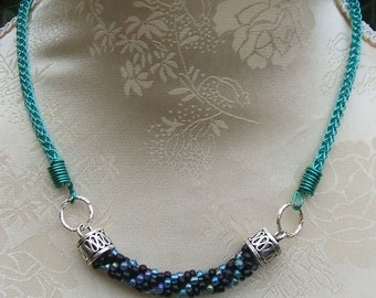 Necklace knitted in turquoise from wire and with crocheted insert made of glass beads