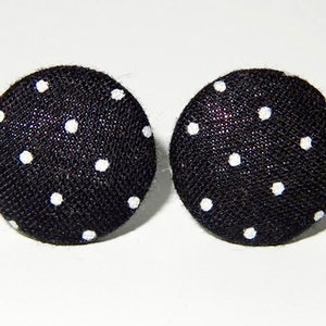 May include: A pair of black fabric earrings with white polka dots.