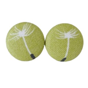 May include: A pair of green fabric button earrings with a white dandelion design.