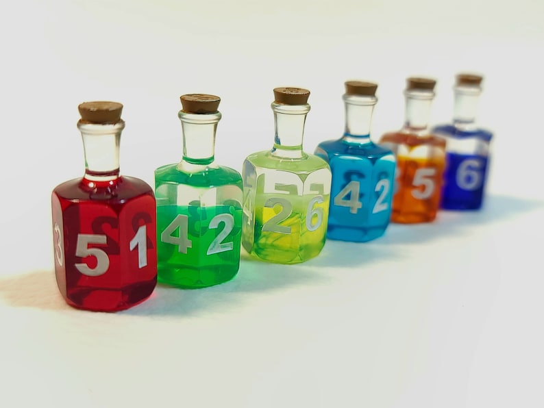 May include: Six small glass bottles with cork stoppers filled with coloured liquids and numbered 3, 4, 2, 5, 4, and 6.