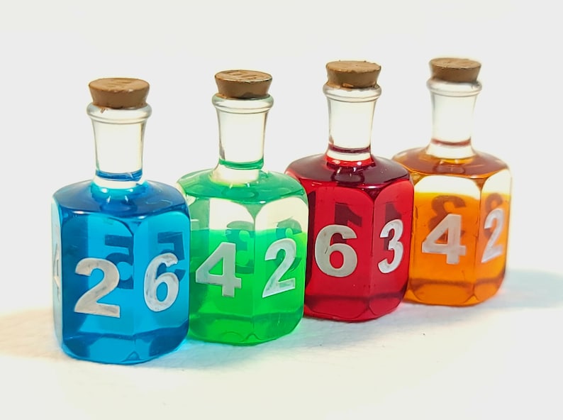 May include: Four small glass bottles with cork stoppers filled with different coloured liquids. Each bottle has a different number on each side: 2, 6, 4, 2, 1, 6, 3, 4, 2.