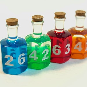May include: Four small glass bottles with cork stoppers filled with coloured liquid and numbered dice faces. The bottles are blue, green, red, and orange.