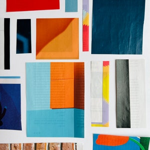 May include: A collage of colorful paper scraps, including red, blue, orange, and yellow. The scraps are arranged in a random pattern on a white background. Some of the scraps have text printed on them.
