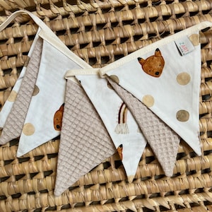 Könnte beinhalten: Eine beige und weiße Stoffgirlande mit einem Fuchs-, Regenbogen- und Tupfenmuster. Die Girlande wird von Zart Made hergestellt.