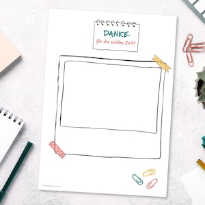 May include: A white sheet of paper with a hand-drawn polaroid frame and the German text "DANKE für die schöne Zeit!" is taped to the top. The image is surrounded by office supplies, including a notepad, pens, paperclips, and a small succulent.