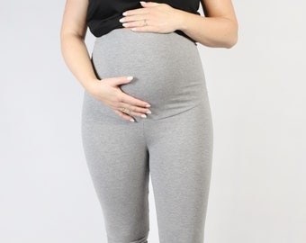 May include: Gray maternity leggings with a high waistband. The leggings are made of a soft, stretchy fabric and are perfect for everyday wear.