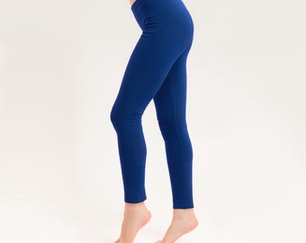 May include: A pair of dark blue leggings.