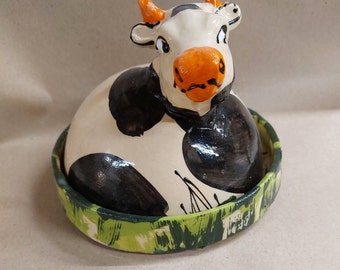 Butter dish or cheese dome round ceramic as a cow in the meadow