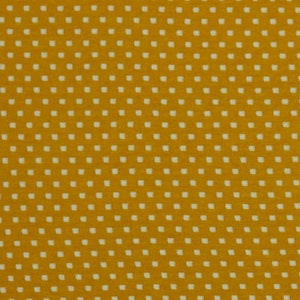 Könnte beinhalten: Ein gelber Stoff mit einem weißen Tupfenmuster.