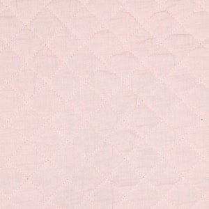 May include: Close-up of a light pink quilted fabric. The fabric has a diamond pattern created by stitched lines. The texture appears soft and slightly wrinkled, with subtle variations in the pink hue across the surface.