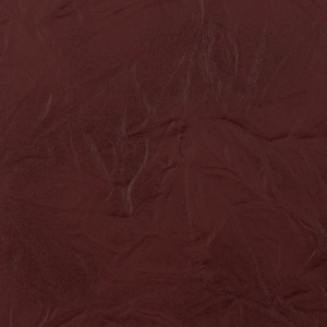 May include: A close-up of a deep burgundy textured fabric. The fabric has a subtle, pebbled texture.