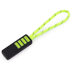 May include: A black zipper pull with a green and black cord. The zipper pull has four rectangular green buttons.