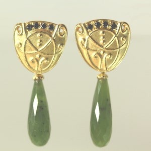Peut inclure: Boucles d'oreilles en or avec une goutte de jade verte et des accents de pierres pr&eacute;cieuses noires.