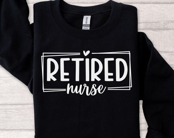 May include: Black sweatshirt with white text that reads "RETIRED nurse" in a box with a small heart above the text.