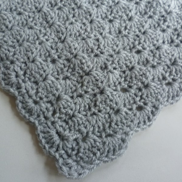 1 crocheted baby blanket in a shell pattern