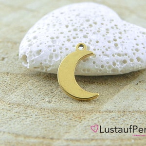 May include: Gold-colored metal crescent moon charm pendant. The charm is on a white heart-shaped rock.