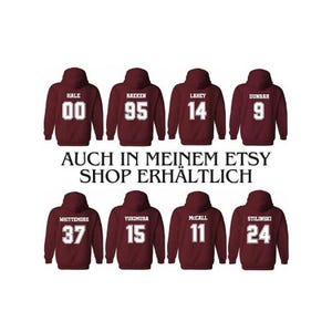 May include: Burgundy hooded sweatshirts with white numbers and names printed on the back. The names include Hale, Raeken, Lahey, Dunbar, Whittemore, Yukimura, McCall, and Stilinski. The numbers include 00, 95, 14, 9, 37, 15, 11, and 24.