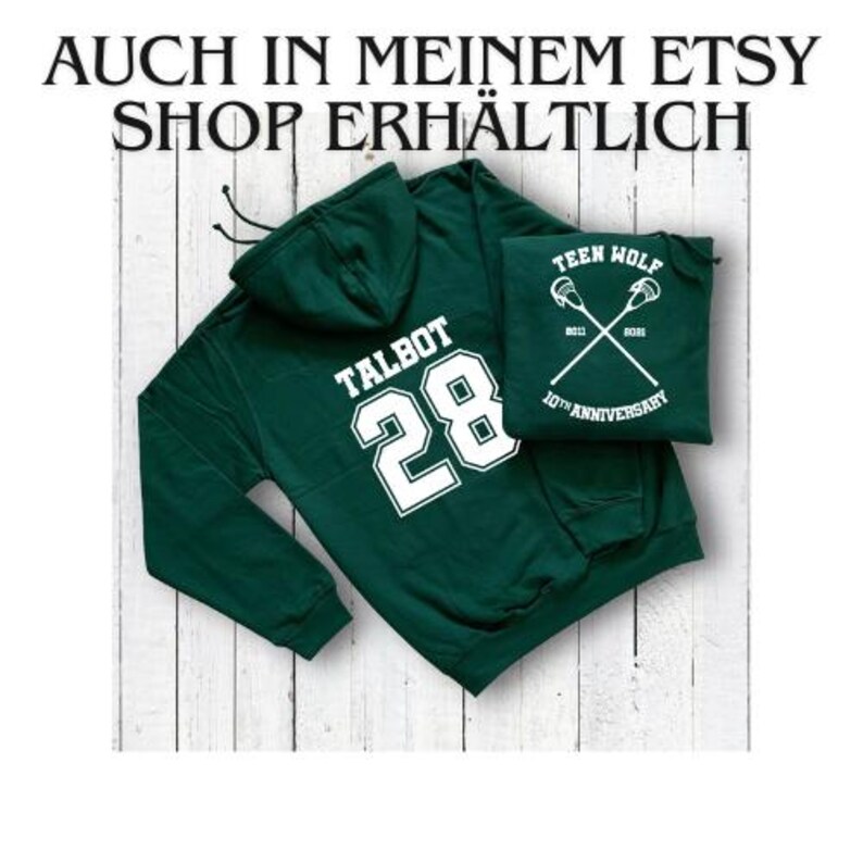 May include: Green hooded sweatshirt with the text "TALBOT 28" printed on the back in white. A smaller white patch with the text "TEEN WOLF 10TH ANNIVERSARY" is attached to the front of the sweatshirt.