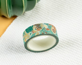 May include: A roll of green washi tape with a floral pattern in gold, brown, and white.