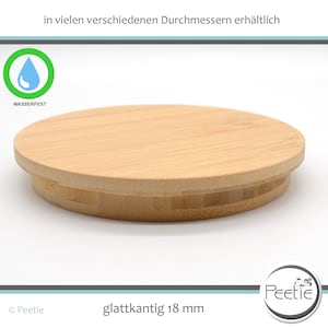 Könnte beinhalten: Runder Deckel aus hellem Bambus mit glatter Oberfläche und leicht erhöhtem Rand. Er ist mit "WASSERFEST" und einem Wassertropfen-Symbol gekennzeichnet. Der Text "glattkantig 18 mm" ist ebenfalls sichtbar.