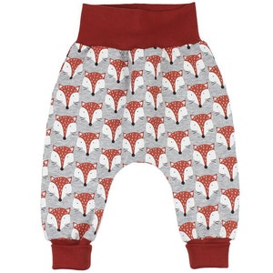 May include: Gray and red baby pants with a fox print. The pants have a red elastic waistband and red cuffs.