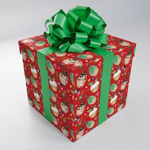 May include: A large, square gift box wrapped in red paper with a repeating pattern of cupcakes, ice cream cones, and other sweets. The box is tied with a wide green ribbon and a large, fluffy green bow on top.