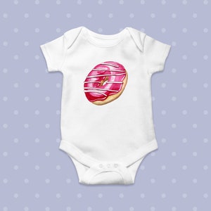 May include: White baby onesie with a pink and white donut graphic.