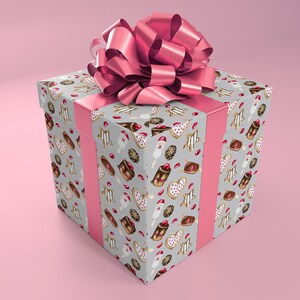 May include: A square gift box wrapped in gray paper with a pink bow. The paper is decorated with a pattern of various pastries, including donuts, cakes, and cookies.