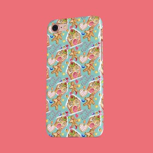 May include: A turquoise phone case with a repeating pattern of gingerbread houses, gingerbread men, candy canes, and stars. The text "Merry Christmas" is repeated throughout the pattern.