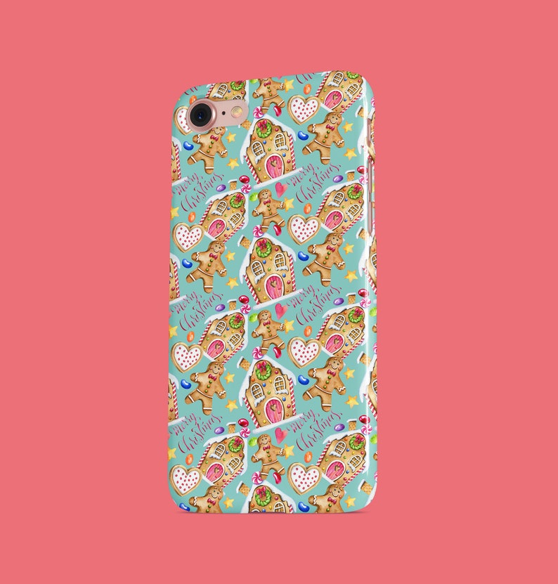 May include: A turquoise phone case with a repeating pattern of gingerbread houses, gingerbread men, candy canes, and stars. The text "Merry Christmas" is repeated throughout the pattern.
