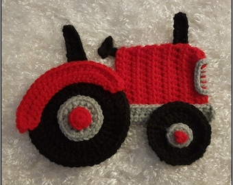May include: A red, black, and gray crocheted tractor toy. The tractor has a large front wheel, a smaller back wheel, and a red body with black details.