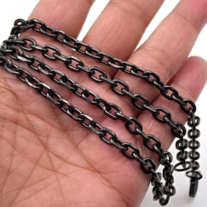 May include: A dark gunmetal chain necklace with oval links. The chain is displayed against a neutral background. The necklace has a lobster clasp closure.