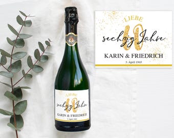 May include: A champagne bottle with a gold label that says "LIEBE sechzig Jahre KARIN & FRIEDRICH 3. April 1965".