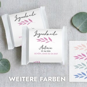 May include: Two white wrapped candies with the text "Jugendweihe" and a pink leaf design. One candy has the name "Antonia" and the date "09. Mai 2026". A card shows leaf designs in pink, blue, and green.
