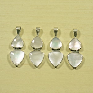 May include: Four silver pendants with white mother-of-pearl triangular stones. Each pendant has two stones, one on top of the other.