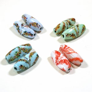 May include: Four pairs of glass beads with different patterns. The beads are oval shaped and have a speckled, marbled, and swirled design. The colors include white, blue, green, and red.