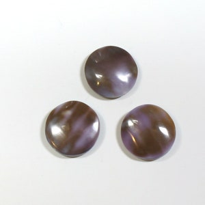May include: Three round, iridescent, mother-of-pearl buttons with a purple and brown swirl pattern.