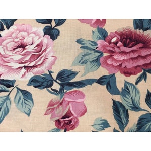 May include: Beige fabric with a floral pattern featuring pink roses and teal green leaves.