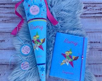 May include: A light blue cone-shaped gift bag and a matching light blue notebook. The cone features a cartoon witch, the name Romy, the year 2026, and pink ribbons. The notebook displays the name Romy, the word Zeugnisse, and a cartoon witch.