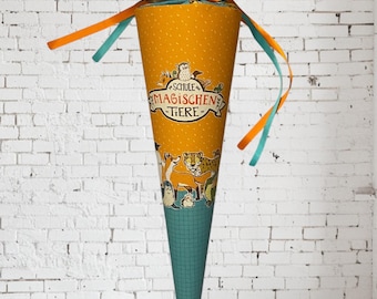 May include: A cone-shaped gift bag featuring a mustard yellow middle section with the text "SCHULE DER MAGISCHEN TIERE" and animal illustrations. The top is teal with a repeating animal pattern, tied with orange and teal ribbons at the neck.