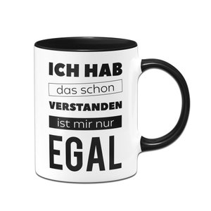 Könnte beinhalten: Weißer Keramikbecher mit schwarzem Innenraum und Henkel. Der Becher zeigt den deutschen Text "ICH HAB das schon VERSTANDEN ist mir nur EGAL" in schwarzer, fetter Schrift.