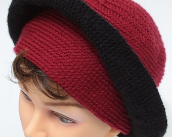 May include: A burgundy crocheted hat with a wide black crocheted band around the brim.
