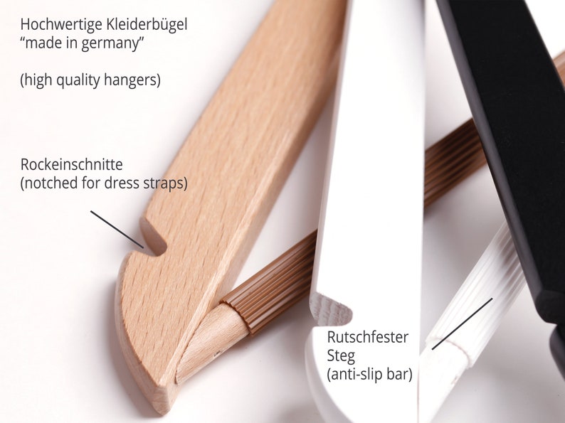 May include: Close-up of three wooden hangers with different finishes. The hanger on the left is natural wood with a notch for dress straps. The middle hanger is white with a brown anti-slip bar. The hanger on the right is black. The text "Hochwertige Kleiderb&uuml;gel "made in germany" (high quality hangers)" is visible at the top of the image. The text "Rockeinschnitte (notched for dress straps)" is visible on the left side of the image. The text "Rutschfester Steg (anti-slip bar)" is visible on the right side of the image.