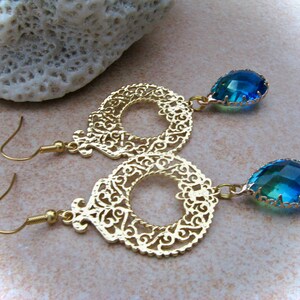 elegant gold-plated brass earrings with green-blue faceted glass drops