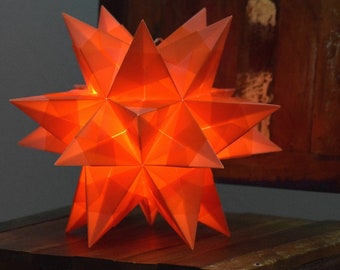 middle illuminated star in four colors red, white, yellow and orange Christmas