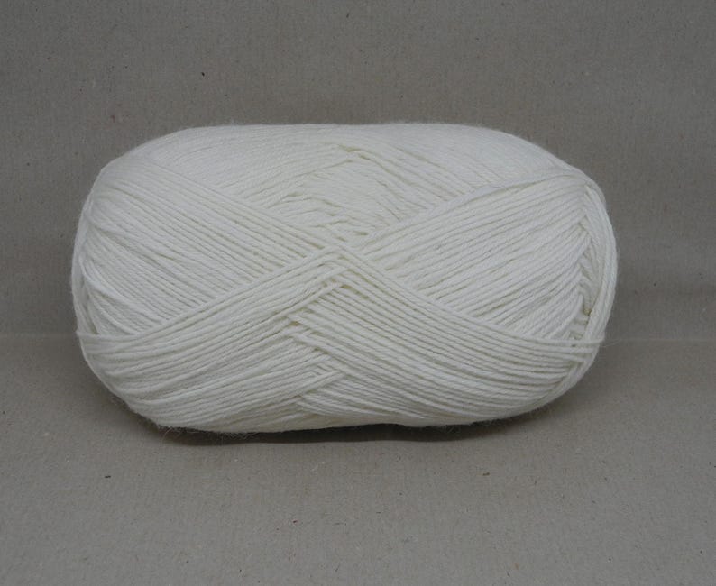 May include: A ball of white yarn, ready for knitting or crocheting.