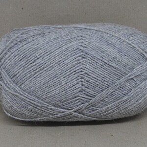 May include: A ball of light grey yarn.