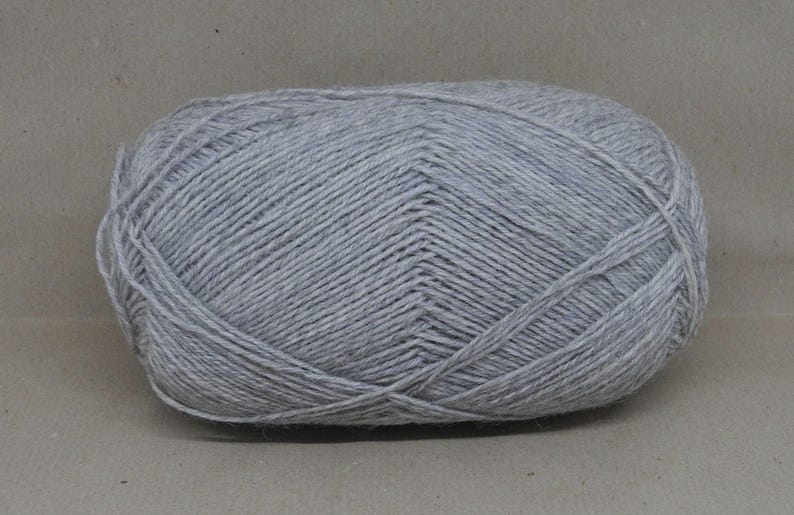 May include: A ball of light grey yarn.