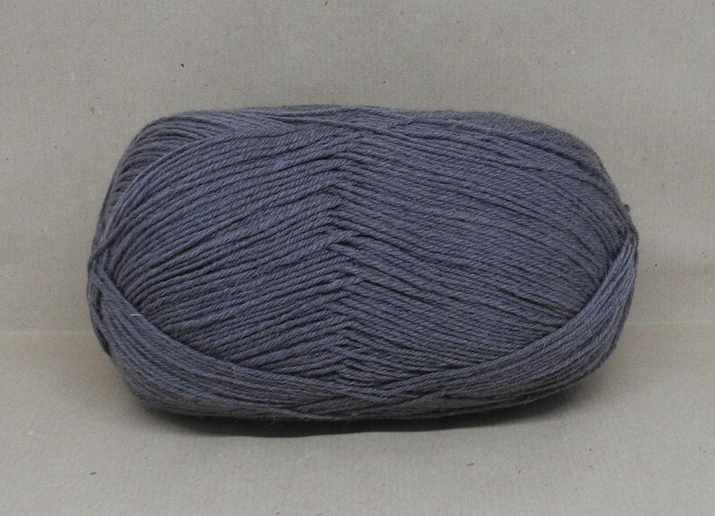 May include: A ball of dark grey yarn.